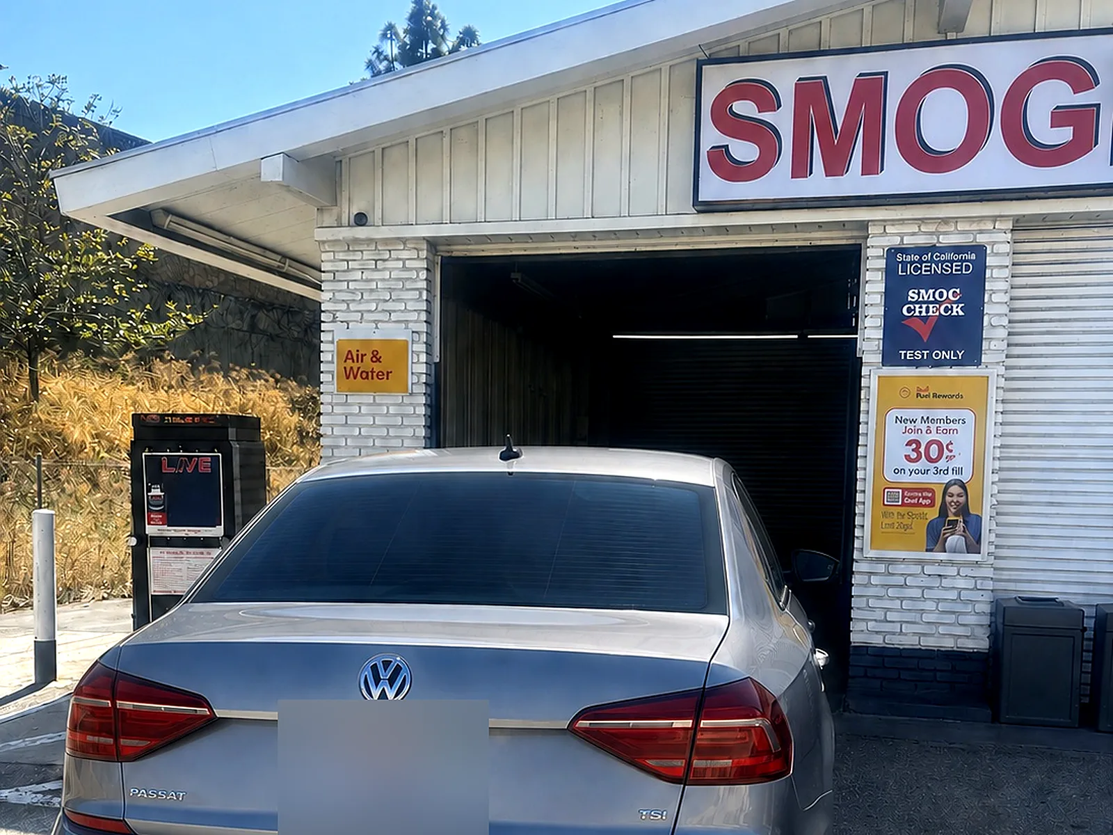 STAR smog check in Garden Grove, CA: our Magnolia St station with the Smog sign and a VW sedan out front